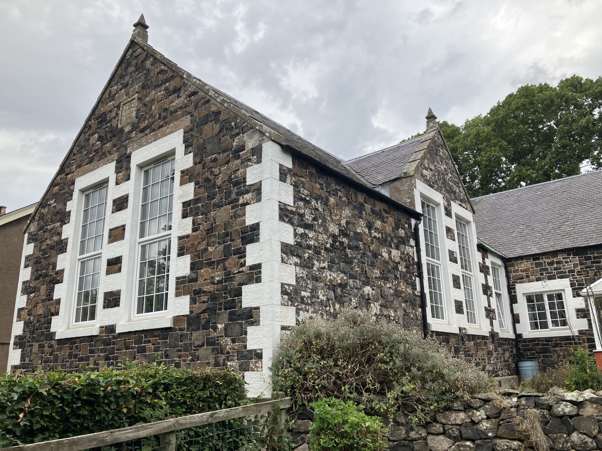 The Old School Studio, a traditional stone building with tall white-framed windows