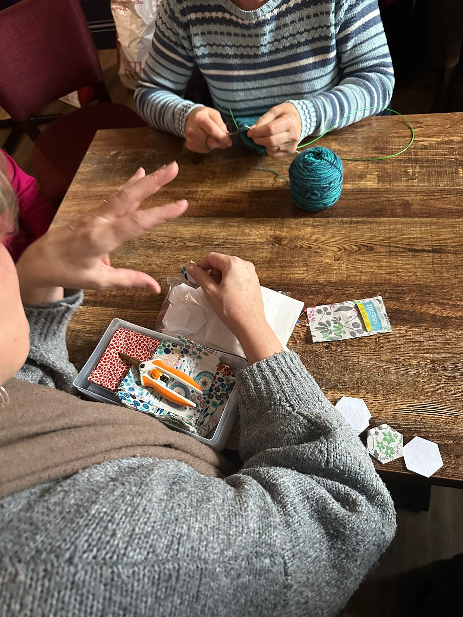 Members knitting and chatting together at Coffee Craft & Chat